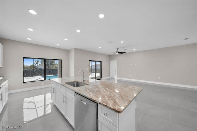 kitchen with dishwasher, a center island with sink, sink, ceiling fan, and white cabinetry