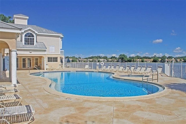 view of swimming pool with a patio area and french doors