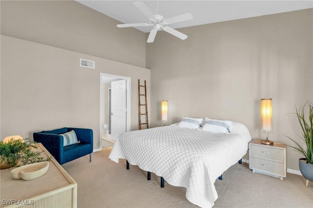 bedroom with connected bathroom, ceiling fan, and light carpet