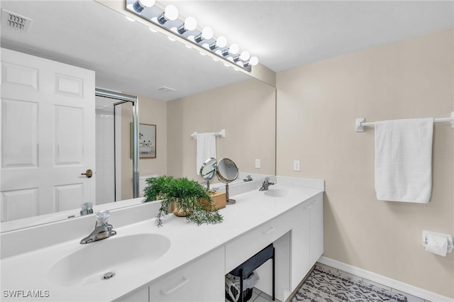 bathroom with vanity and a shower with shower door