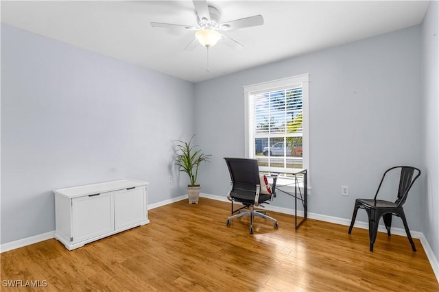 home office featuring light hardwood / wood-style floors and ceiling fan