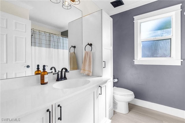 bathroom with vanity, toilet, wood-type flooring, and ornamental molding