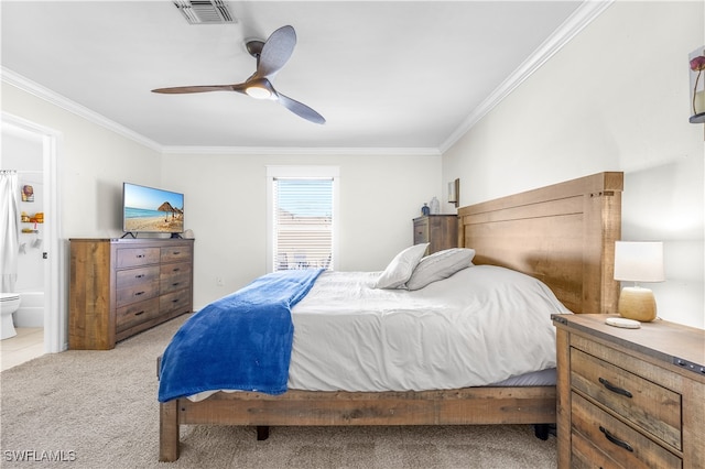 carpeted bedroom featuring ensuite bathroom, ceiling fan, and ornamental molding