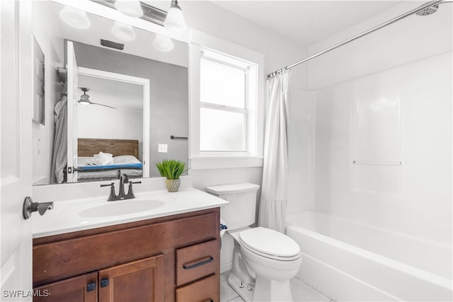 full bathroom featuring ceiling fan, shower / bath combo with shower curtain, vanity, and toilet