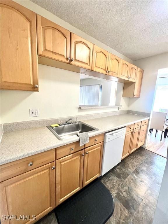 kitchen featuring dishwasher, light brown cabinetry, a textured ceiling, and sink