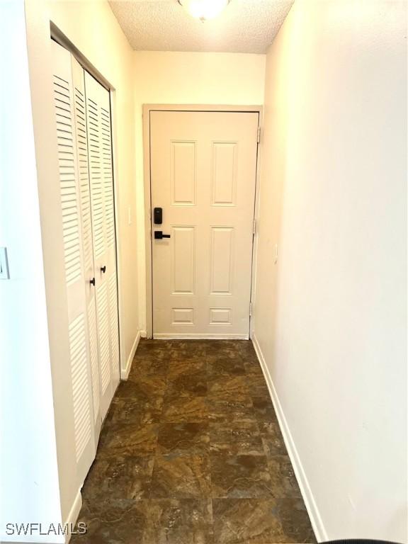 hallway featuring a textured ceiling