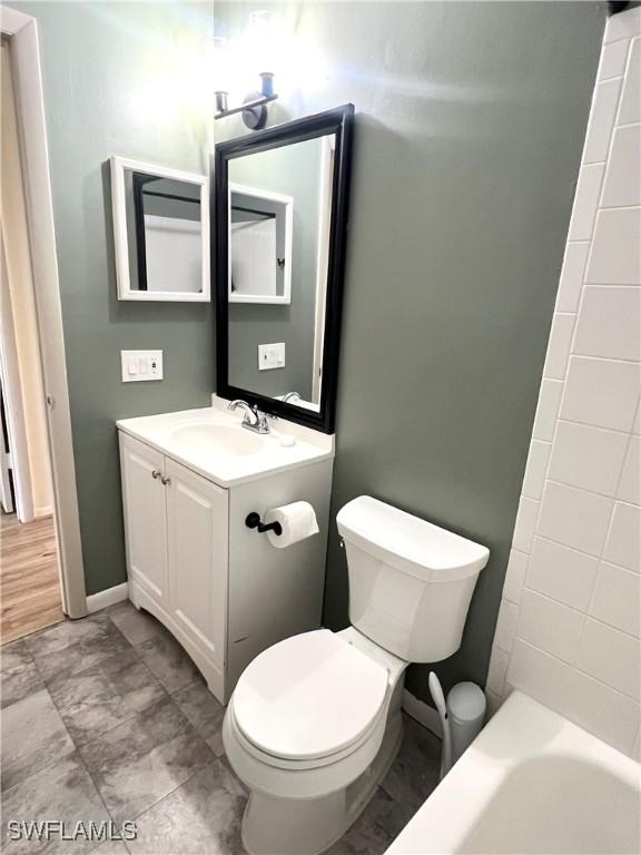 full bathroom featuring vanity, toilet, and bathtub / shower combination