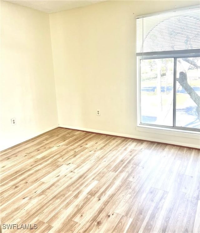 unfurnished room with light hardwood / wood-style floors