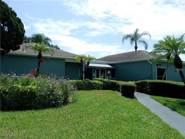 ranch-style house with a front lawn