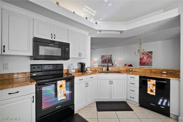 kitchen with kitchen peninsula, sink, black appliances, white cabinetry, and light tile patterned flooring