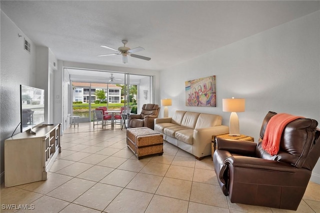 living room featuring ceiling fan and light tile patterned floors