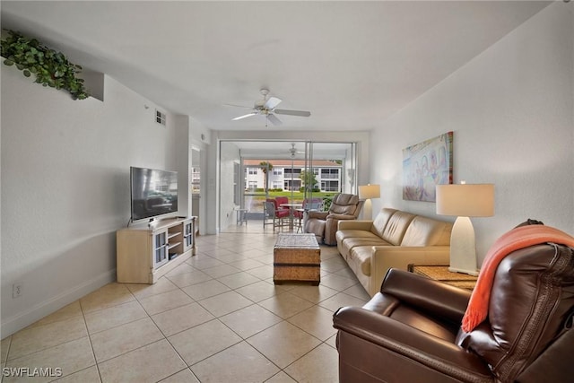 tiled living room featuring ceiling fan