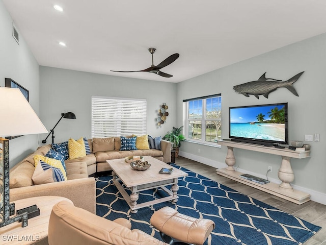 living room featuring hardwood / wood-style flooring and ceiling fan