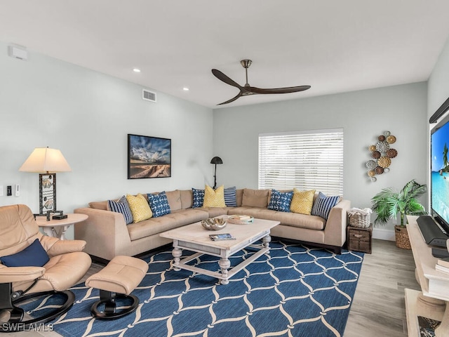 living room with hardwood / wood-style floors and ceiling fan