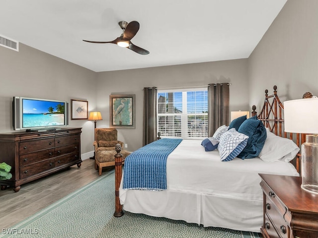 bedroom with light hardwood / wood-style flooring and ceiling fan