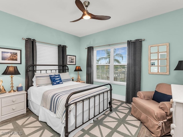 bedroom with ceiling fan and light hardwood / wood-style flooring