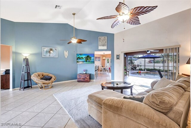 living room featuring light tile patterned floors and high vaulted ceiling