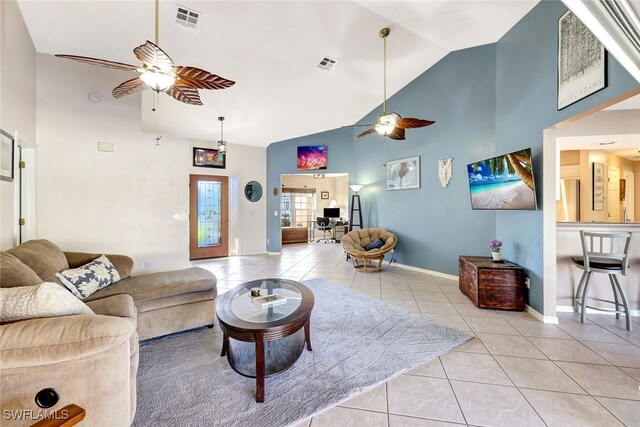 tiled living room with high vaulted ceiling