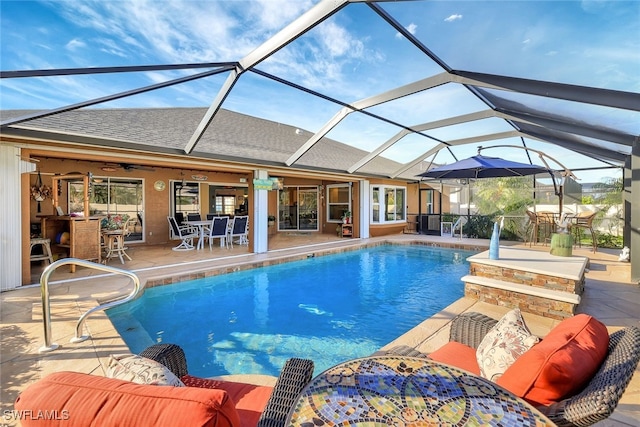 view of swimming pool with a lanai, a patio area, and ceiling fan