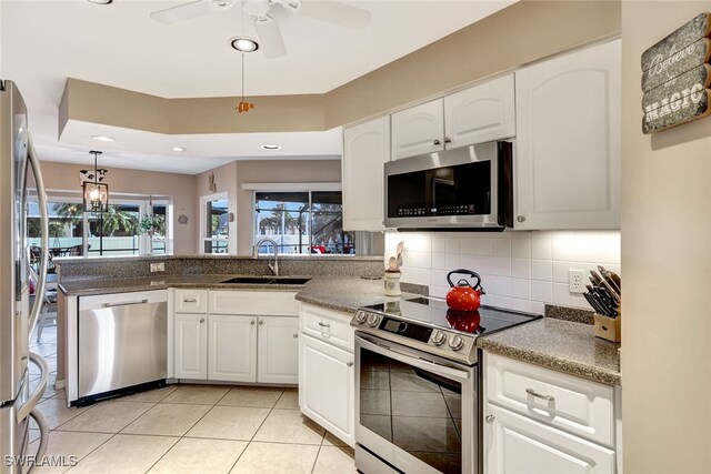 kitchen featuring white cabinets, sink, ceiling fan, appliances with stainless steel finishes, and light tile patterned flooring