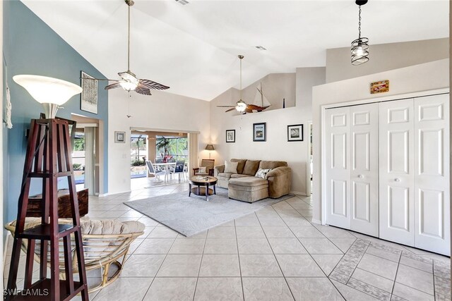 living room with high vaulted ceiling, ceiling fan, and light tile patterned flooring