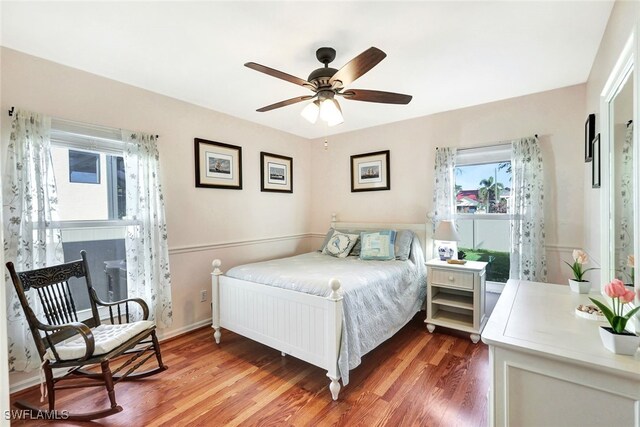 bedroom featuring ceiling fan and dark wood-type flooring