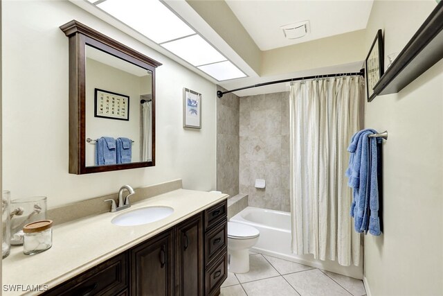 full bathroom with tile patterned flooring, vanity, toilet, and shower / bath combo with shower curtain