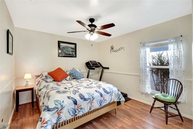 bedroom with ceiling fan and hardwood / wood-style flooring