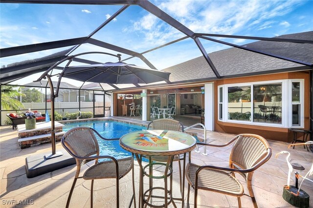 view of pool with a lanai and a patio