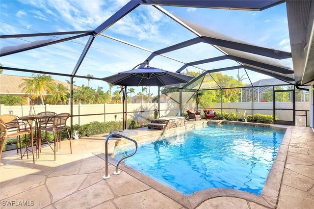 view of pool featuring a lanai, a patio area, and pool water feature