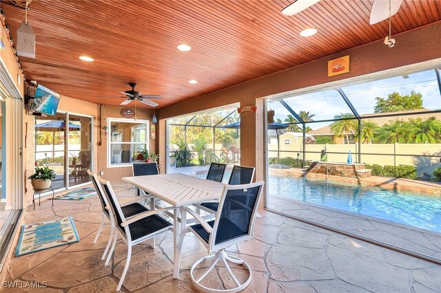 sunroom / solarium featuring ceiling fan