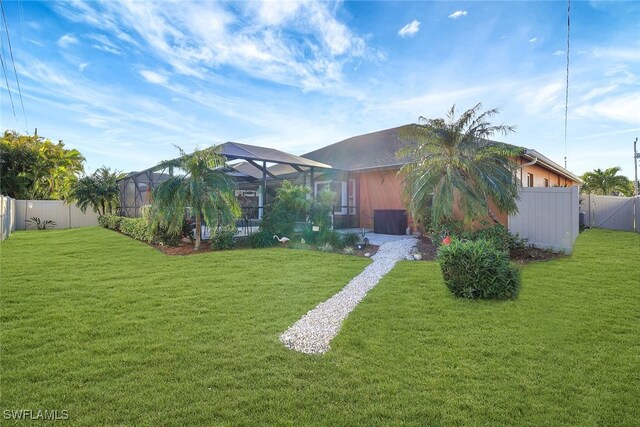 exterior space featuring glass enclosure and a front lawn