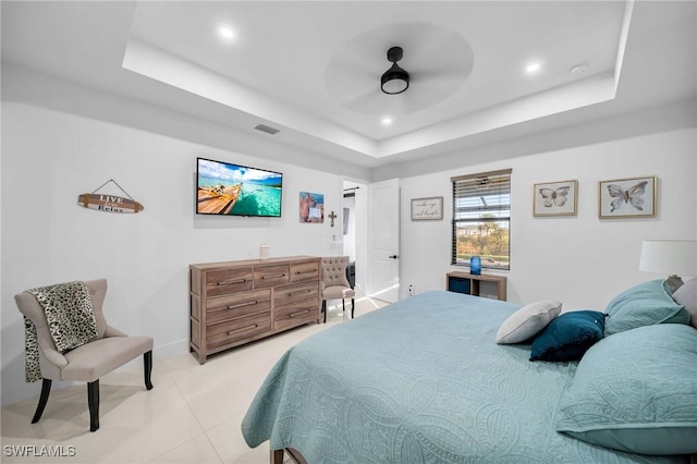 bedroom featuring ceiling fan and a tray ceiling