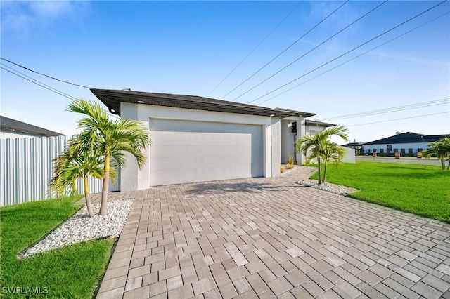 view of front of property featuring a garage and a front yard