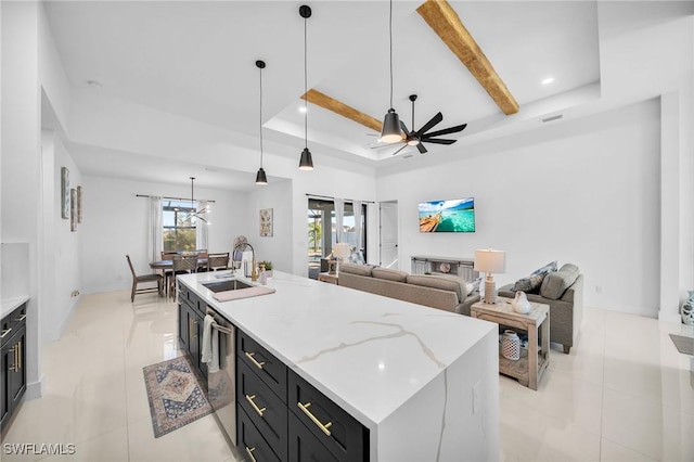 kitchen featuring a kitchen island with sink, sink, hanging light fixtures, ceiling fan, and light tile patterned flooring