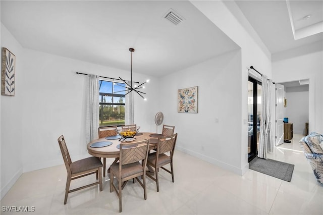 dining room featuring a chandelier and light tile patterned floors