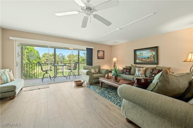 living room with light wood-type flooring and ceiling fan