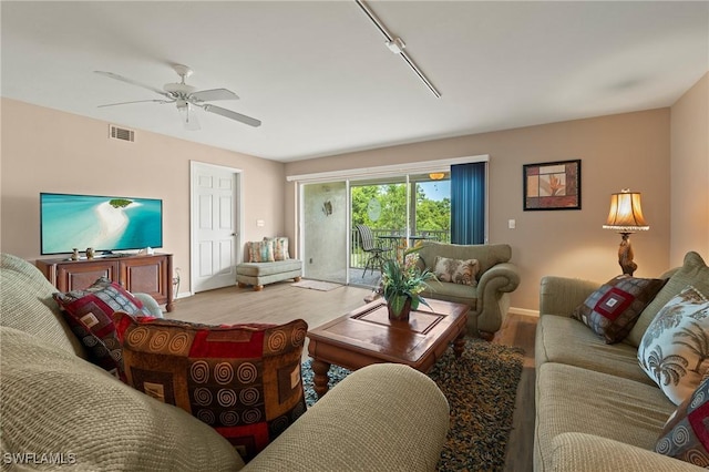 living room with light hardwood / wood-style floors and ceiling fan