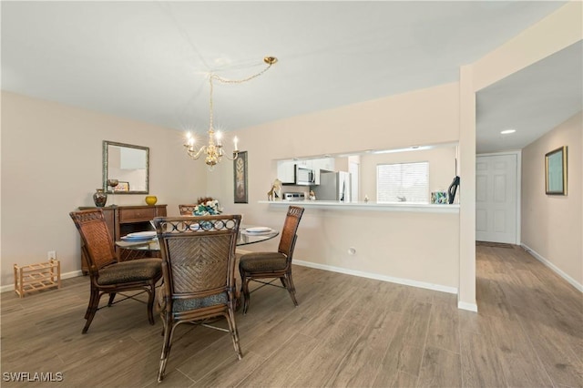 dining room with a chandelier and light hardwood / wood-style floors