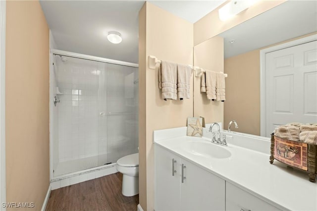 1051 Eastham Way Unit B-204, Naples, FL 34104 - bathroom with a stall shower, toilet, vanity, and wood finished floors