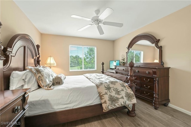 bedroom featuring wood-type flooring, multiple windows, and ceiling fan