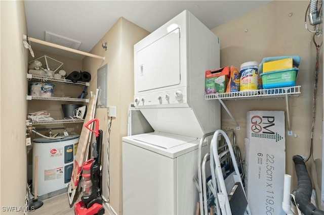 1051 Eastham Way Unit B-204, Naples, FL 34104 - laundry area with stacked washer and clothes dryer and water heater