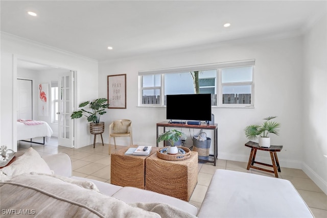 tiled living room featuring french doors and ornamental molding