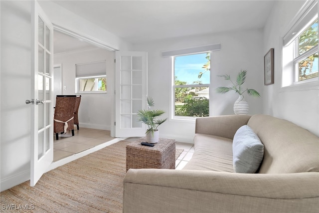 tiled living room with french doors and plenty of natural light