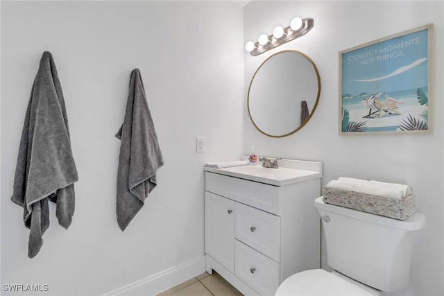 bathroom with tile patterned floors, vanity, and toilet