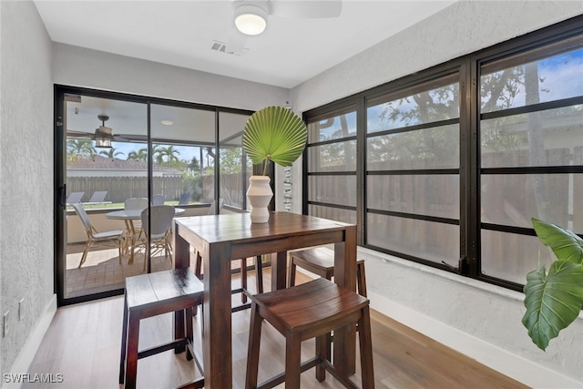 dining space with plenty of natural light, ceiling fan, and wood-type flooring