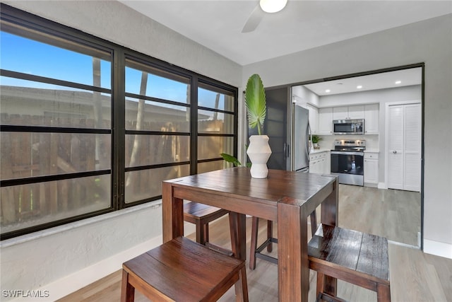 dining room featuring ceiling fan and light hardwood / wood-style flooring