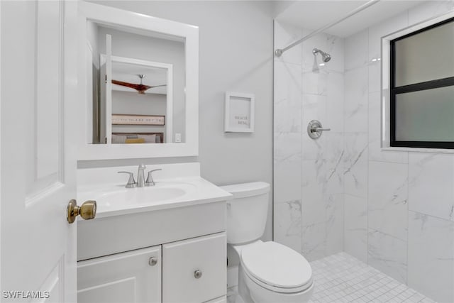 bathroom featuring tiled shower, vanity, and toilet