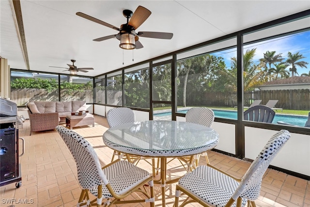 sunroom featuring ceiling fan and a healthy amount of sunlight