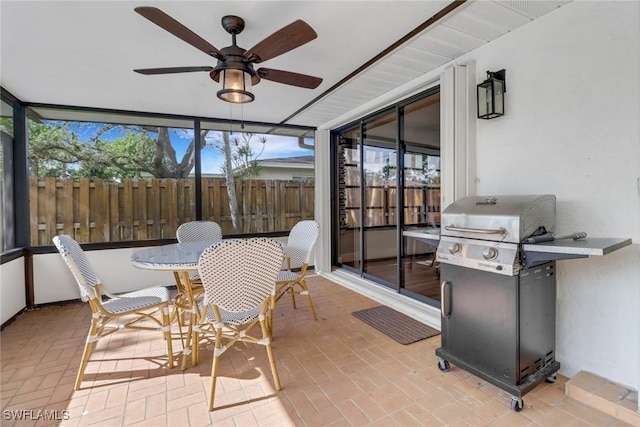 sunroom featuring a wealth of natural light and ceiling fan